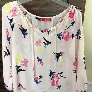 Sheer, light pink blouse.